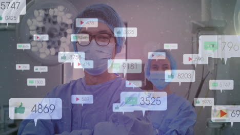 lead surgeon standing arms crossed under surgical lamp in hospital showing floating social icons
