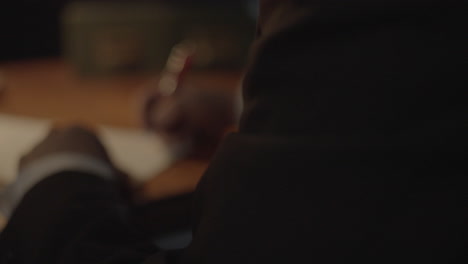 Businessman Signing Documents at Night