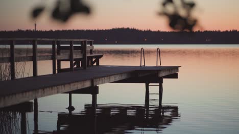 wooden pier by a lake after the sunset