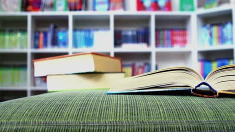 an open book on sofa in library at school