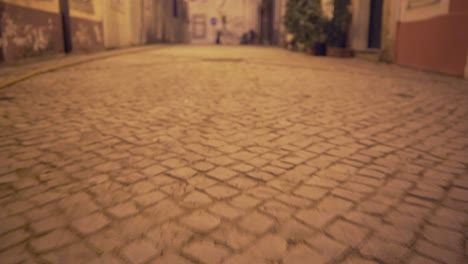 Old-and-typical-street-at-night-with-traditional-pavement-with-lantern-reflection