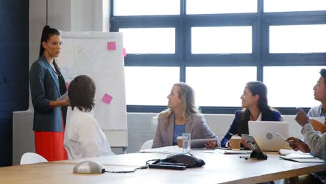 business executives applauding a colleague after presentation