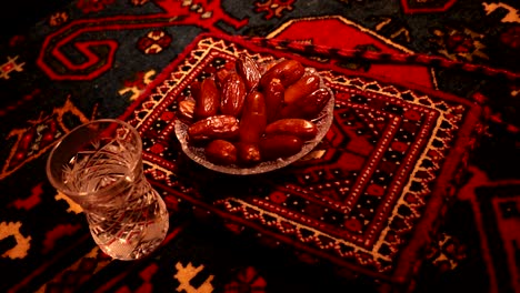 water and dates. iftar is the evening meal. slider view of decoration ramadan kareem holiday. festive greeting card, invitation for muslim holy month ramadan kareem. dark background. selective focus
