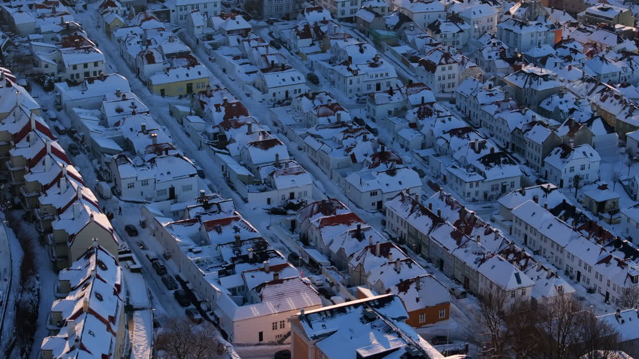 Winter mood in Bergen with snow on the roofs and between the old houses on a cold, sunny day