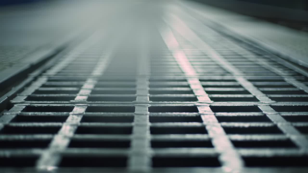 A Close-Up View of a Metal Grate Surface, Showcasing Its Pattern and Texture Under Subtle Lighting Conditions, Ideal for Industrial or Architectural Themes