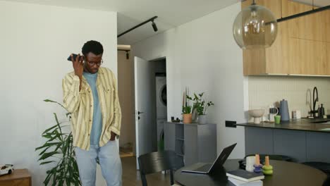 man using smartphone in a modern home