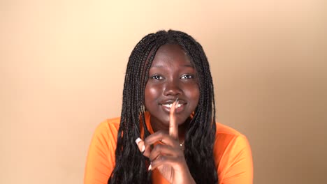 black woman showing silence gesture