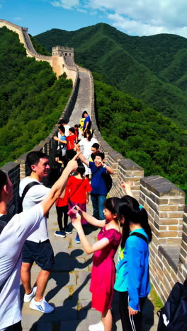 group of people taking photos at the great wall of china