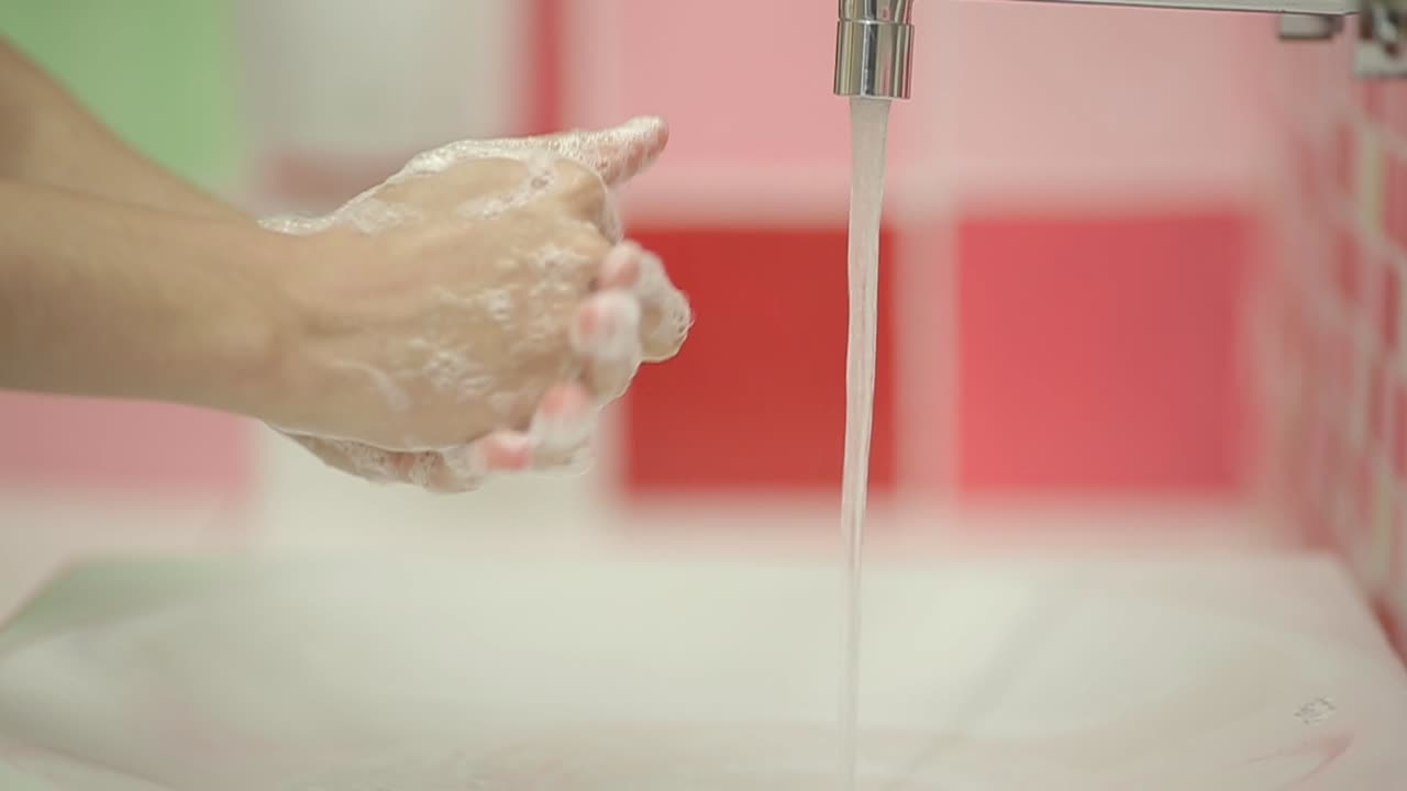 Person Washing Hands with Soap and Water in Bathroom Sink | Premium ...