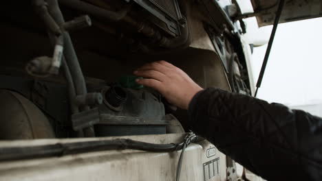 man opening oil deposit