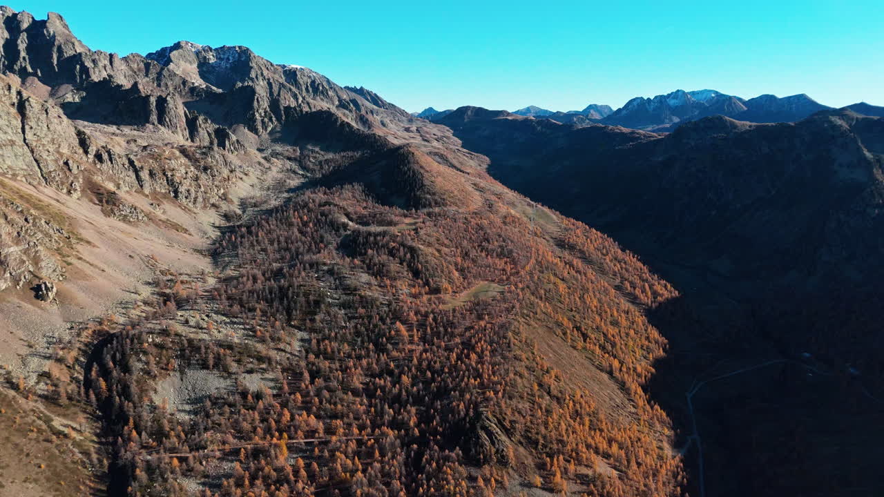 Colle della Lombarda in autumn colors, mountains and clear blue sky