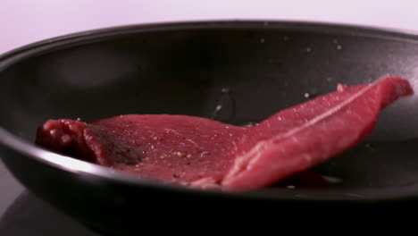 steak falling in a hot pan