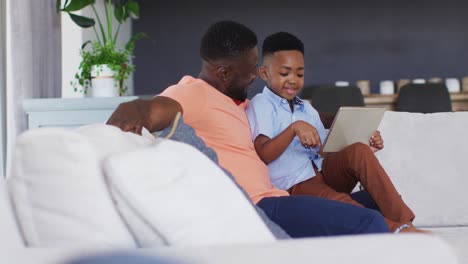 African-american-father-and-son-using-a-digital-tablet-together