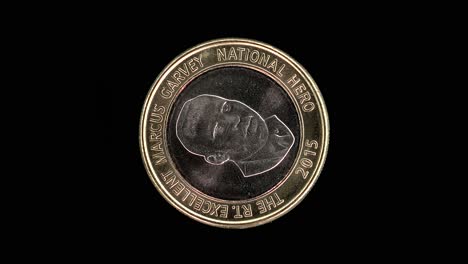 Jamaica 2015 20 dollars coin reverse with Marcus Garvey portrait rotating on black background
