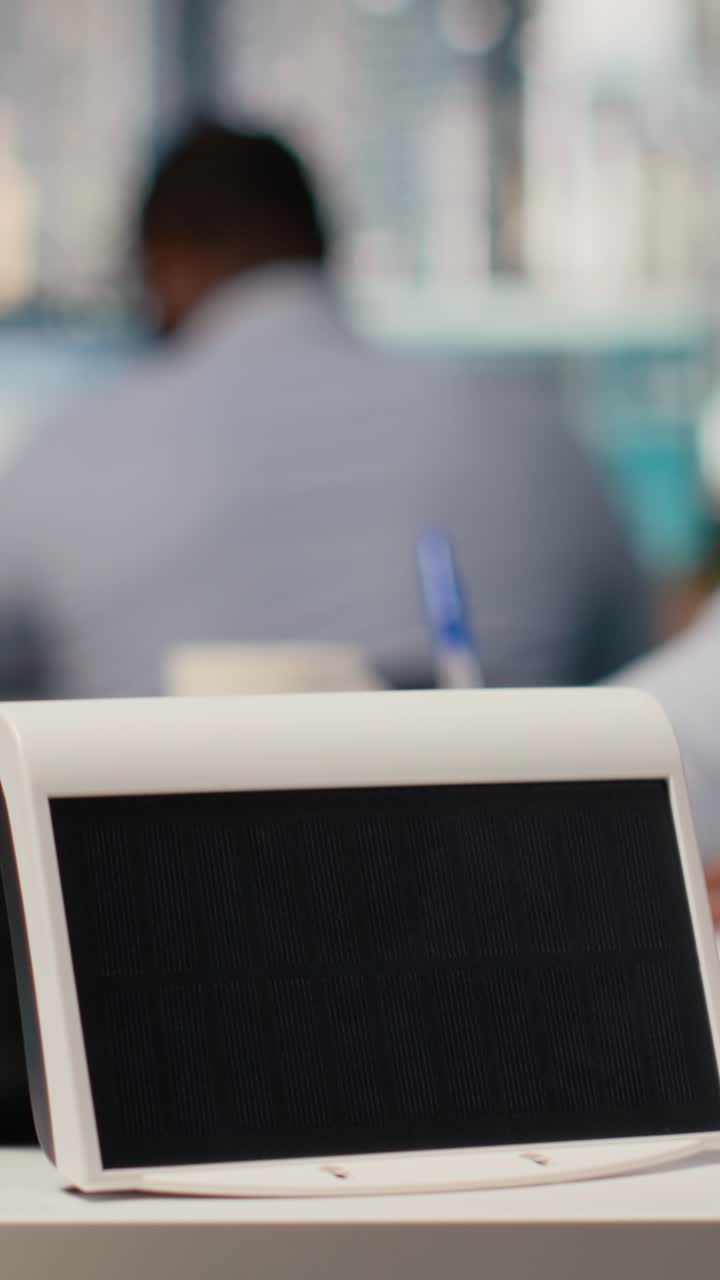 Close up of compact solar powered device in engineering office