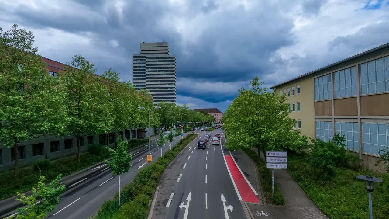 Urban traffic on a city street under cloudy skies