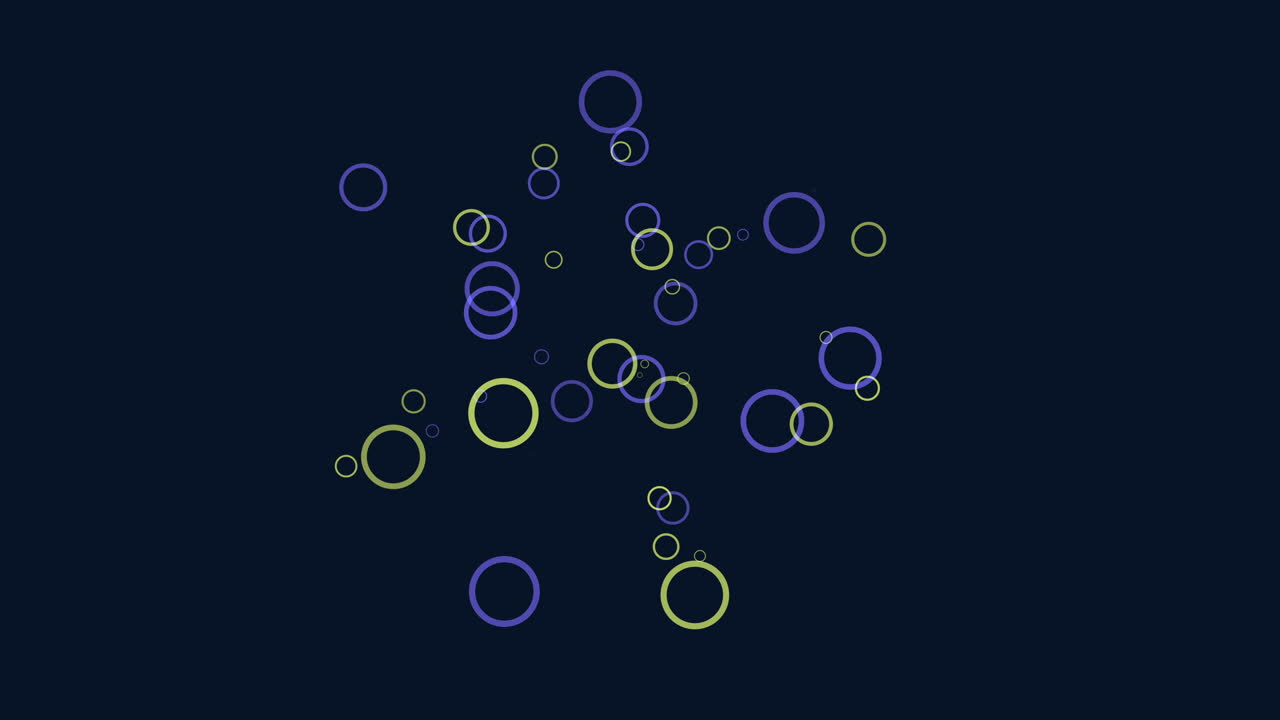 Circular pattern of colorful circles in shades of blue, green, and yellow set against a dark background