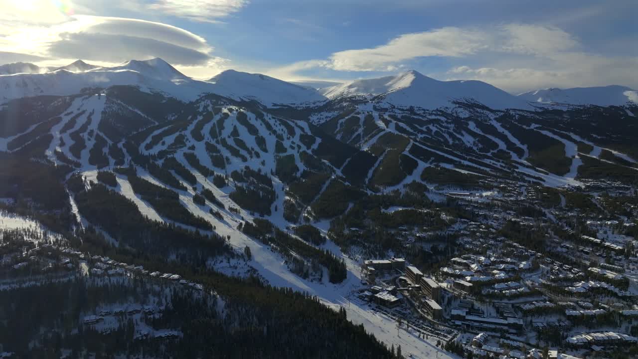 Sunset Breckenridge Ski Resort mountain town Colorado aerial drone Winter December January skiing trails run Peak 9 10 Ten Mile Range Epic Vail Pass cirrus clouds chairlifts forward pan up motion