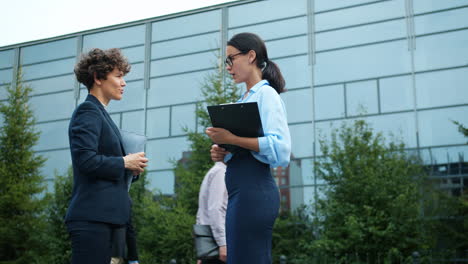 business women discussing outdoors