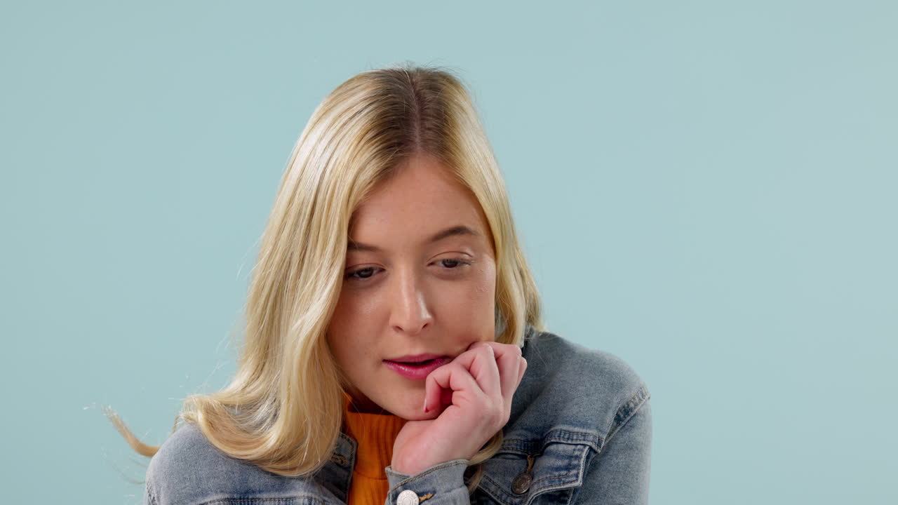 Thinking, stress and woman biting nails in studio
