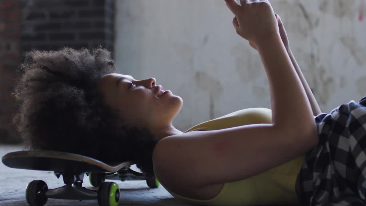 Woman lying on skateboard tapping phone and causing brain HUD forming around head in tech demo