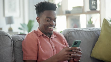 Man,-couch-and-texting-with-smile