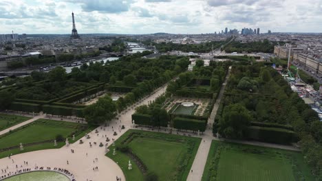 Jardin-des-Tuileries-gardens-in-Paris-with-Eiffel-tower-and-La-Defence-district-in-background