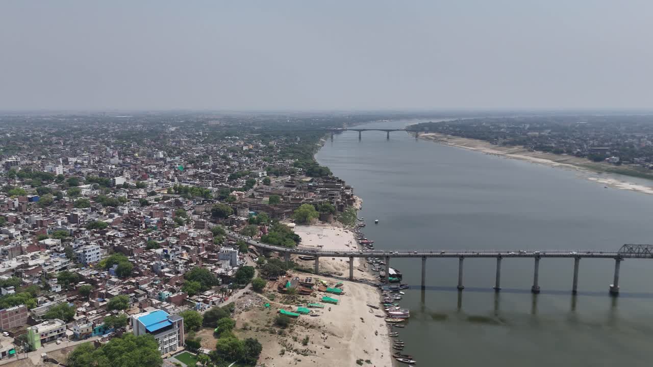 High-altitude shot capturing the vibrant chaos of Varanasi's narrow lanes and tightly packed houses, where every corner holds echoes of centuries-old traditions.