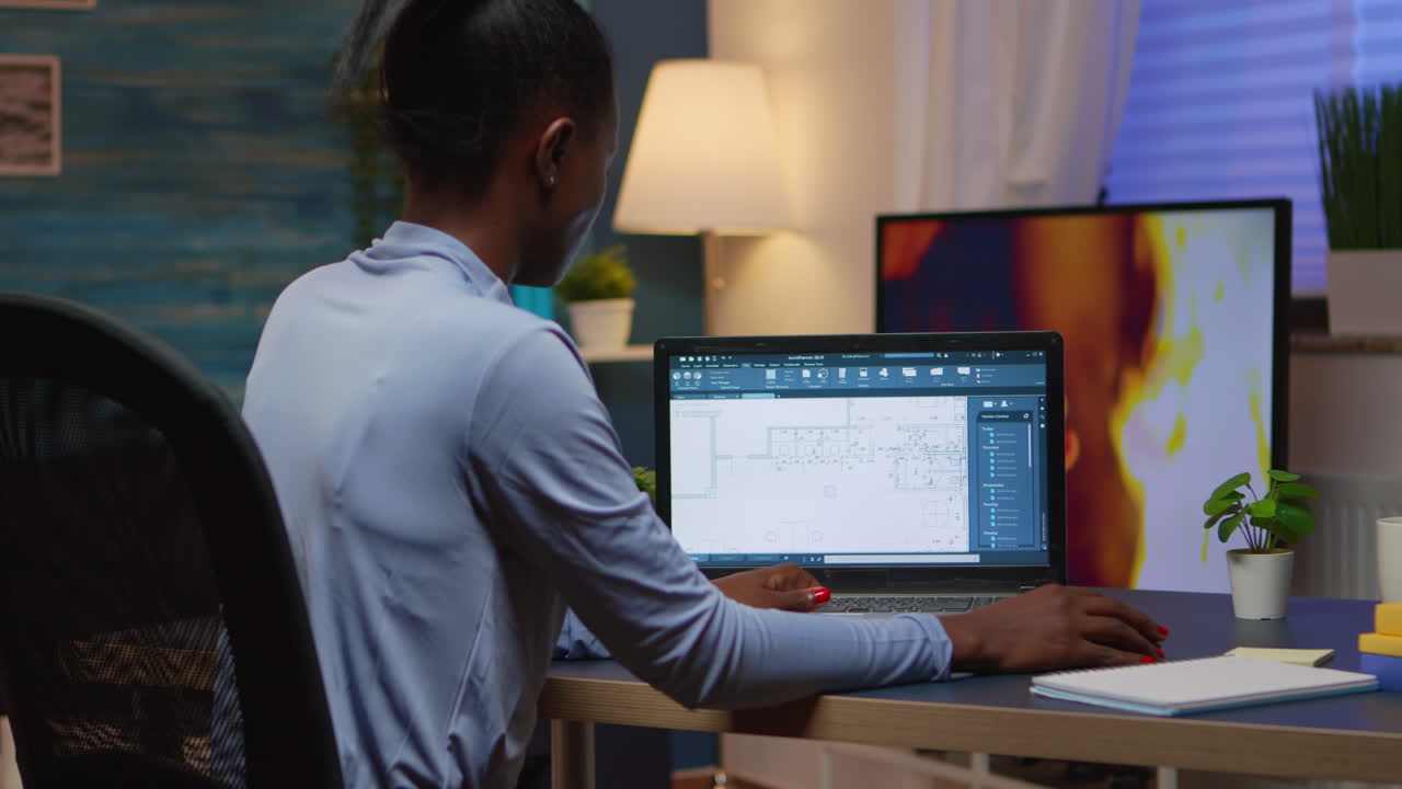 Black employee checking digital blue prints analysing project