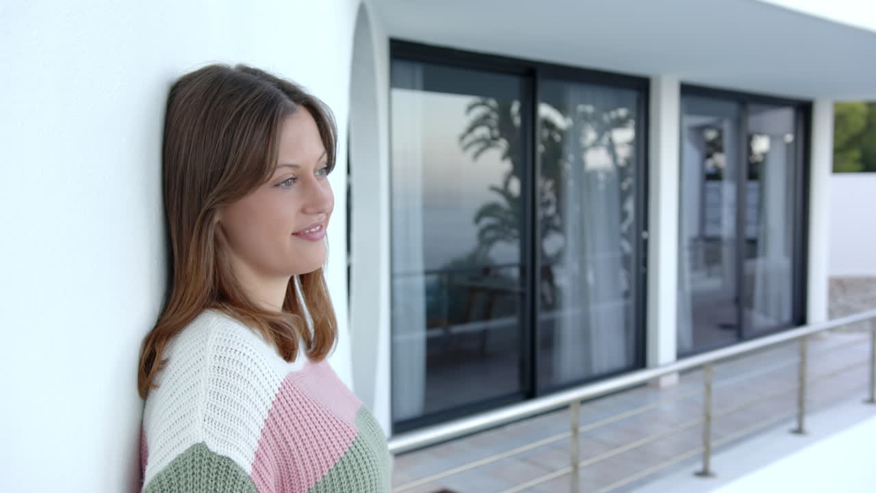 Relaxing at home, young woman in colorful sweater enjoying serene environment, copy space