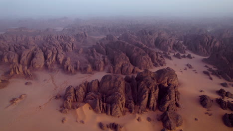 foggy landscape of tassili n'ajjer national park at sunrise in djanet, algeria