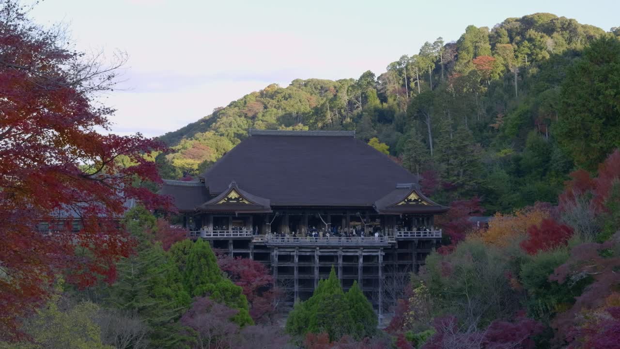 People enjoying views out from platform at Kiyomizudera in Kyoto, Japan in fall