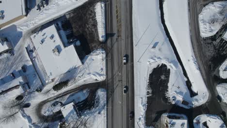 drone view of country roads and houses in winter season with fresh snow