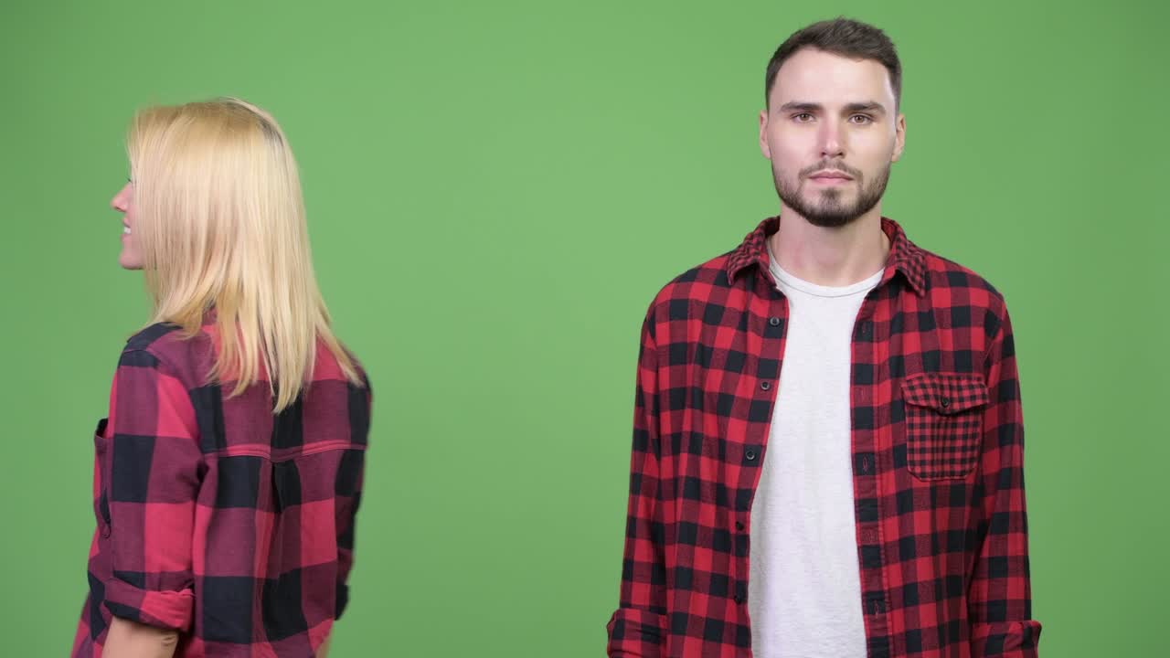 Young woman turning around and smiling after with young man