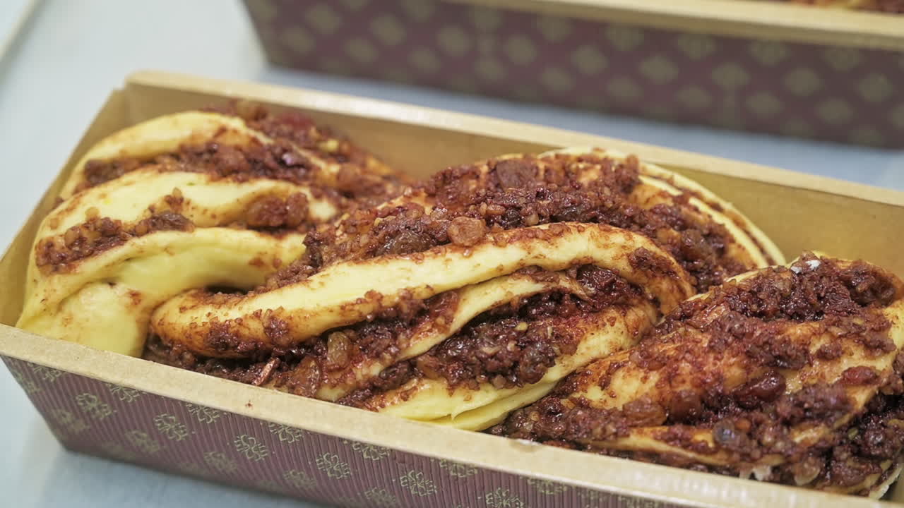 Raw dough with filling in a mold for making baked rolls. Slow motion