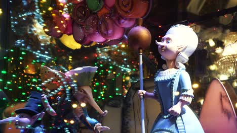 christmas window display with figurines and lights