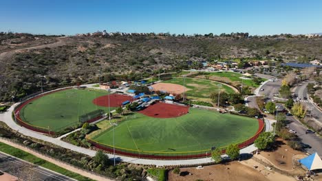 drone rotating right to left to capture football and baseball field in alga norte park, carlsbad, california