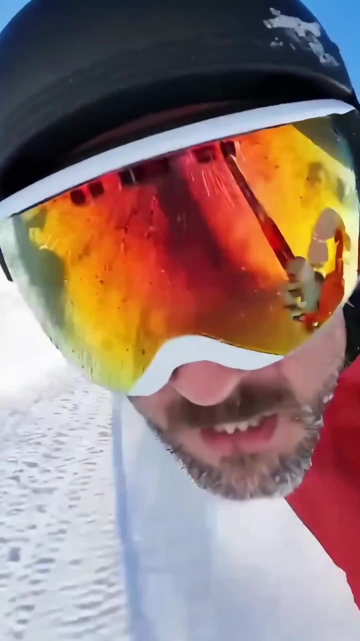 Professional Skier Racing Downhill in Red Suit