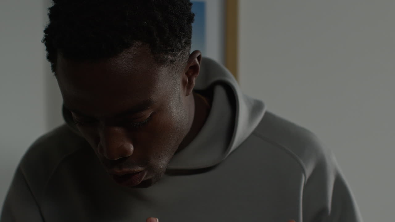 Close Up Of Unhappy And Depressed Young Man At Home Ending Call After Talking On Mobile Phone 1