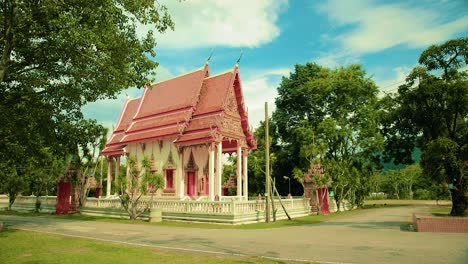 traditional thai temple in natural surroundings of trees in thailand