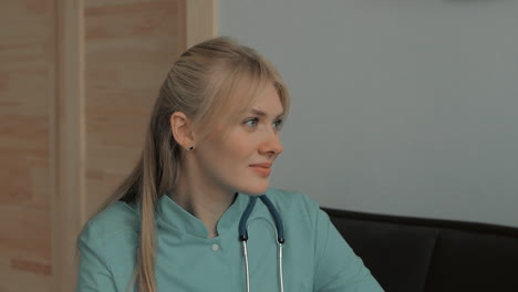 Portrait-Of-Young-Pretty-Blonde-Female-Caring-Nurse-Listening