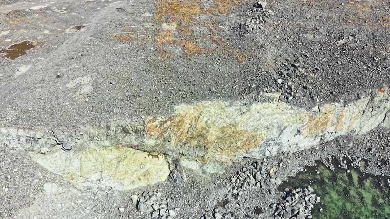 Granite quarry site showing uneven terrain and exposed rocks during daylight