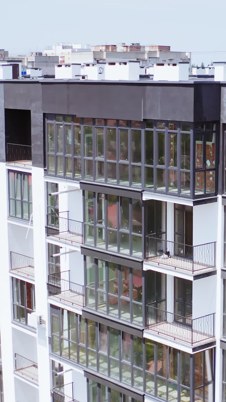 Multi storey building apartments. Exterior of new high rise multi story apartment building. Vertical video