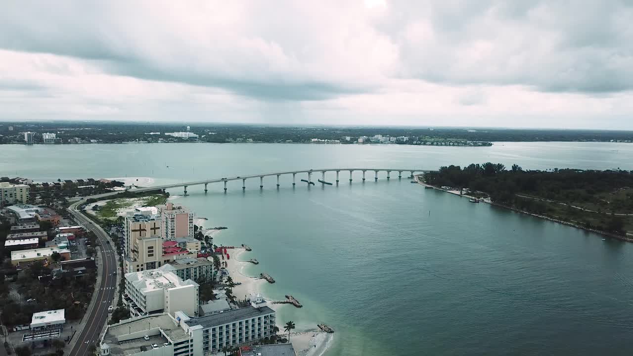 Aerial view of Causeway Bridge and hotels in Clearwater, Florida, Dark Clouds, Backward