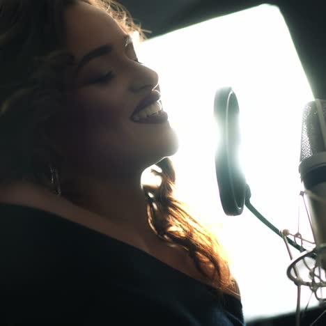 woman singing in the recording studio. profile of a woman with a beautiful face and lips.