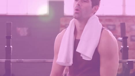 Animation-of-glowing-light-over-fit-man-exercising-in-gym
