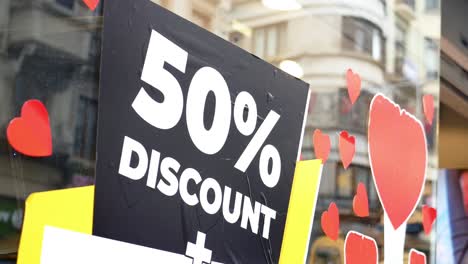 50% off discount sign in shop window