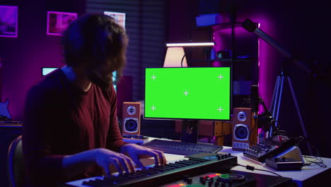 artist learning to play at electronic piano keyboard in home studio