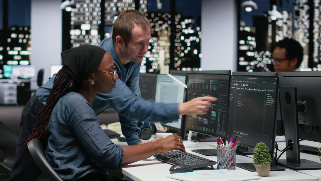 Diverse Team of Software Developers Collaborating on Code in Modern Office