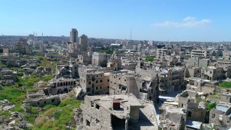 aerial view with a drone above the ancient city in the middle of aleppo in syria. we still can see buildings destroyed even 10 years after the war 4k